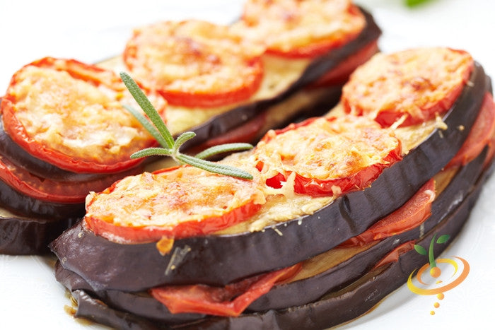 Fresh eggplant (aubergine) from Florida Market seeds by SeedsNow, showcasing ripe, glossy purple fruit on the plant.